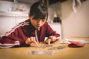 お金の残りを数えている女性